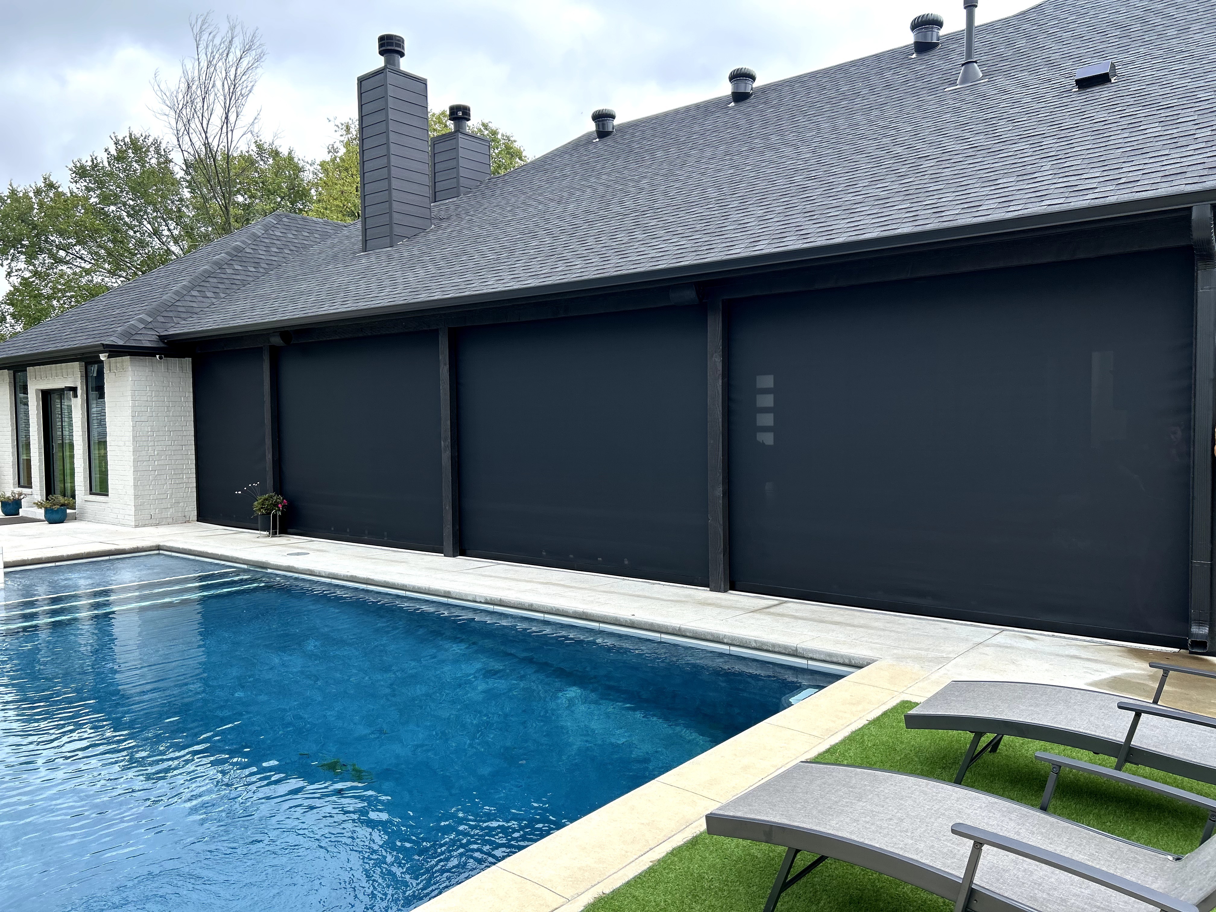 Motorized patio shades by a pool